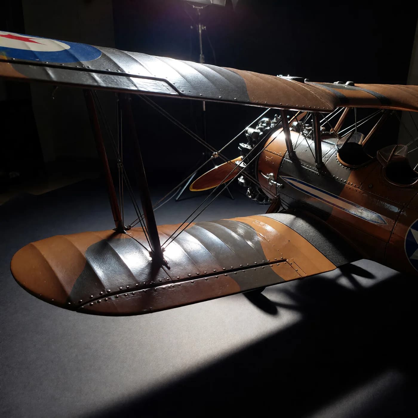 a biplane flying through a canyon at sunrise, wingtip close, dark studio product, one hard key, glossy, no text, no watermark, generated with Imagineart 1.5 Pro Preview Text To Image on Knowlify