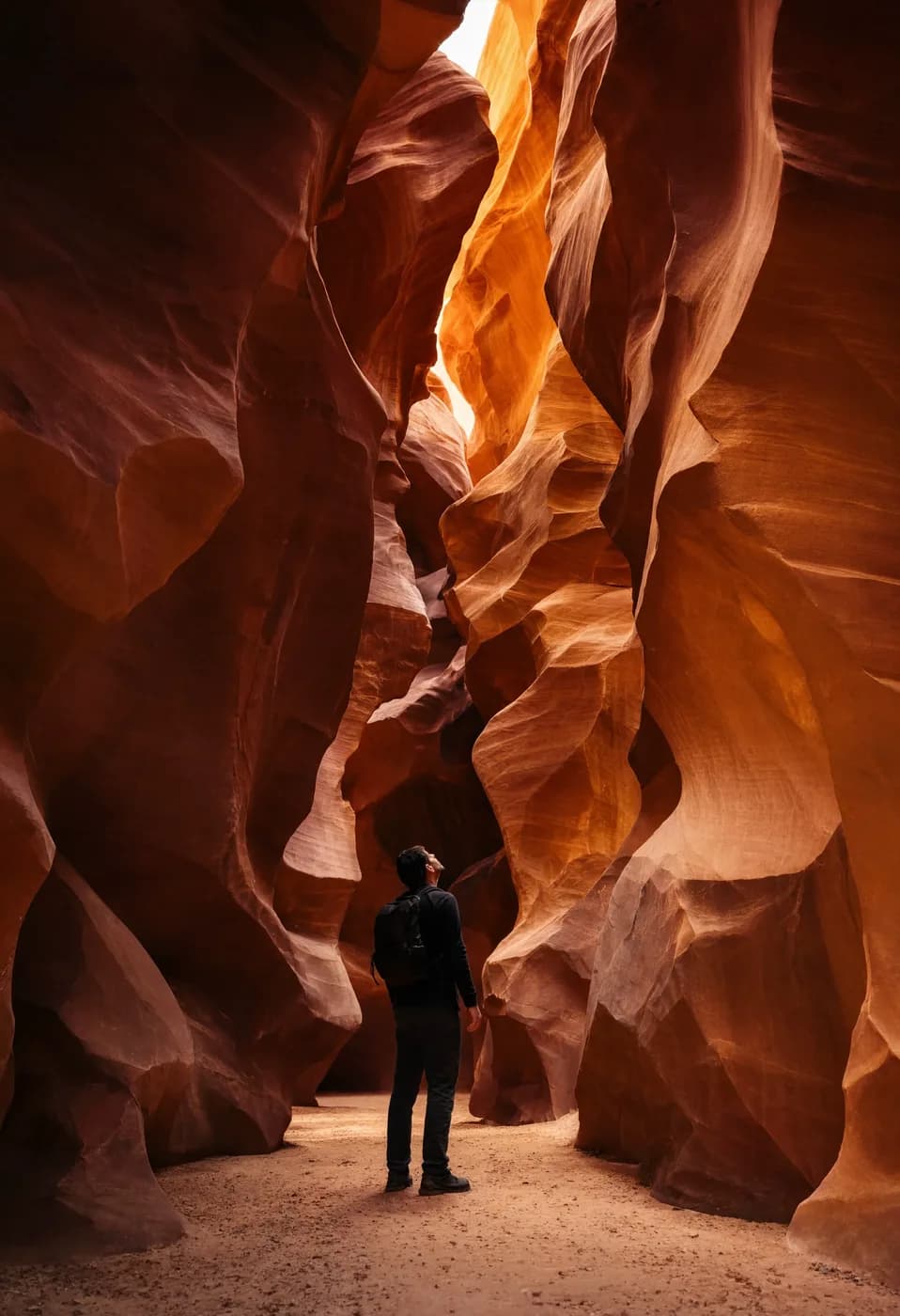 a canyon slot with a person looking up, sandstone glow, octane 3D render, subsurface, chrome accents, no text, no watermark, generated with Reve 2 on Knowlify